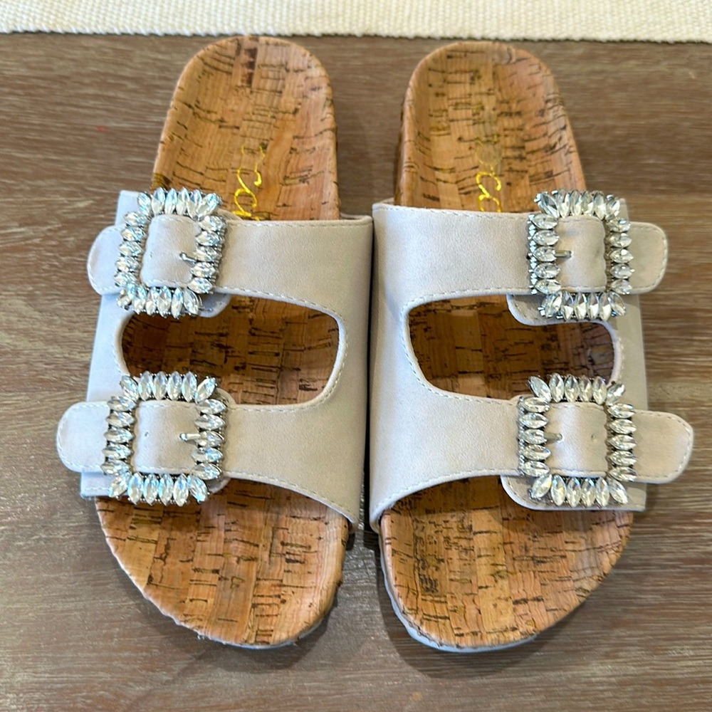 Slip on sandlels, be suede straps with diamond buckles. Size 7..
